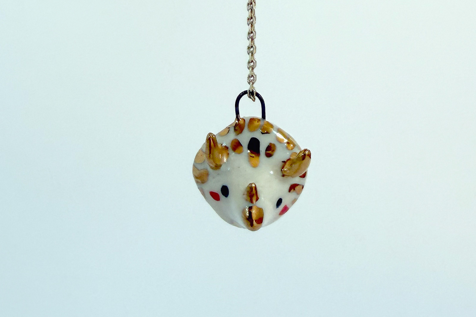 Alternative view of Porcelain and Gold Triceratops Pendant