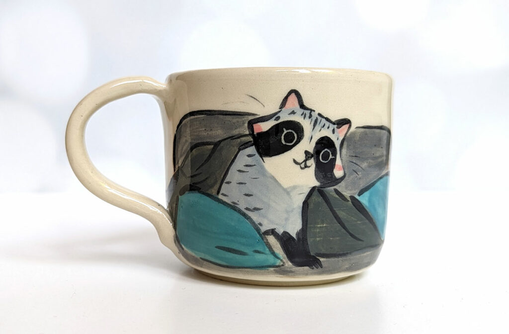 raccoon on the porch mug