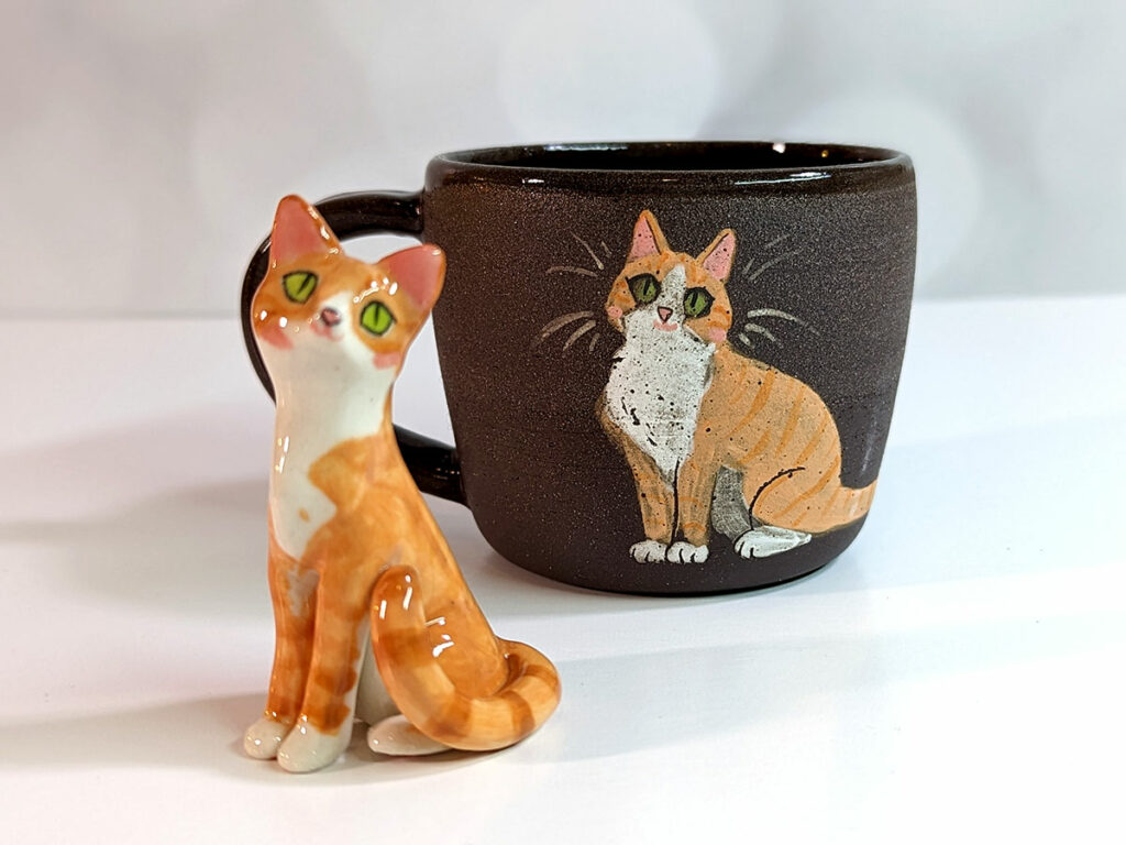 mug and figurine of a ginger cat