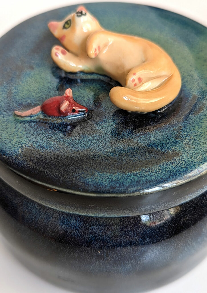 detail of the toy on an urn
