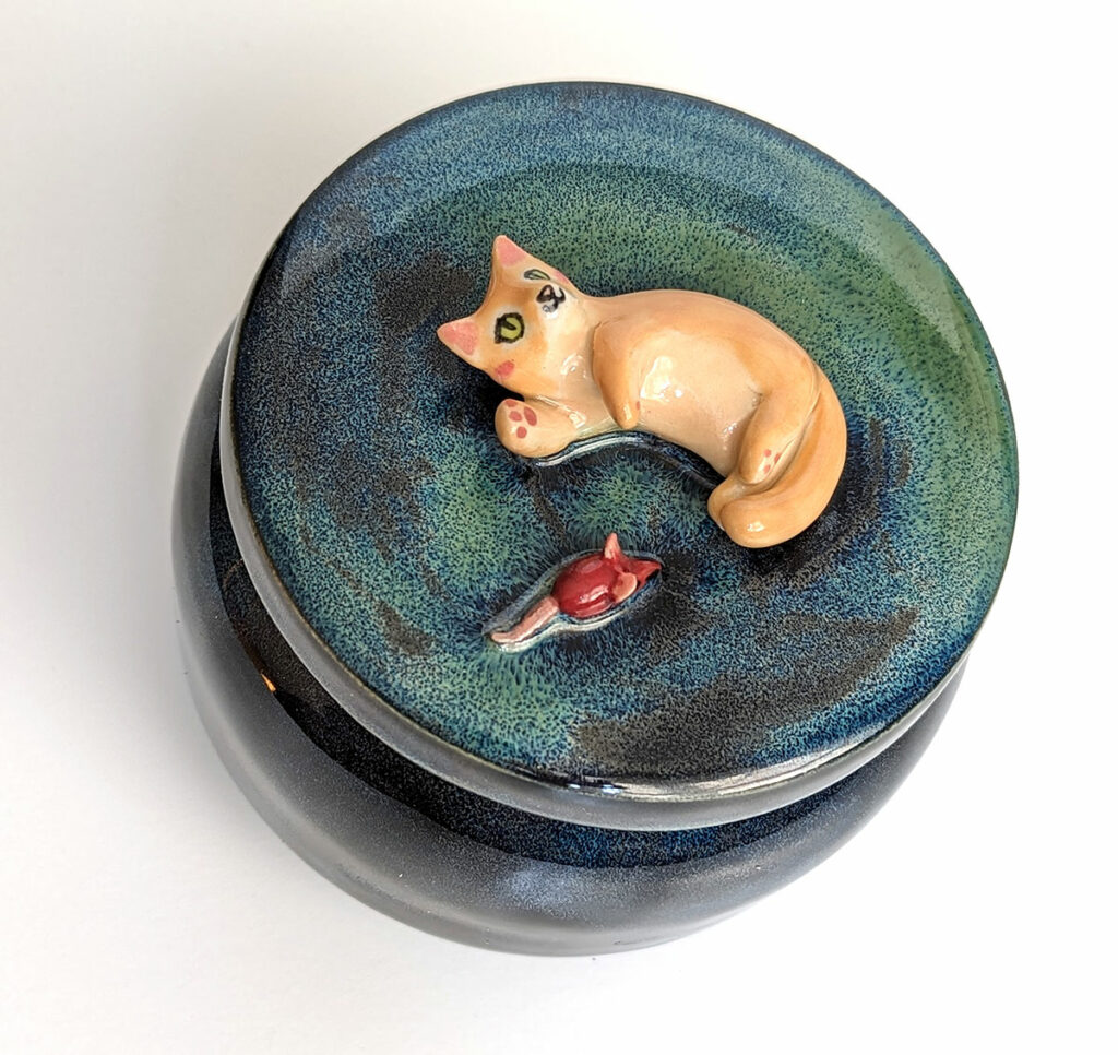 Artemis got an Aurora Borealis urn with his favorite red mouse toy to rest in peace.